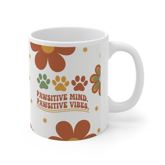 White mug with floral design and text 'PAWSITIVE MIND, PAWSITIVE VIBES' on a white background