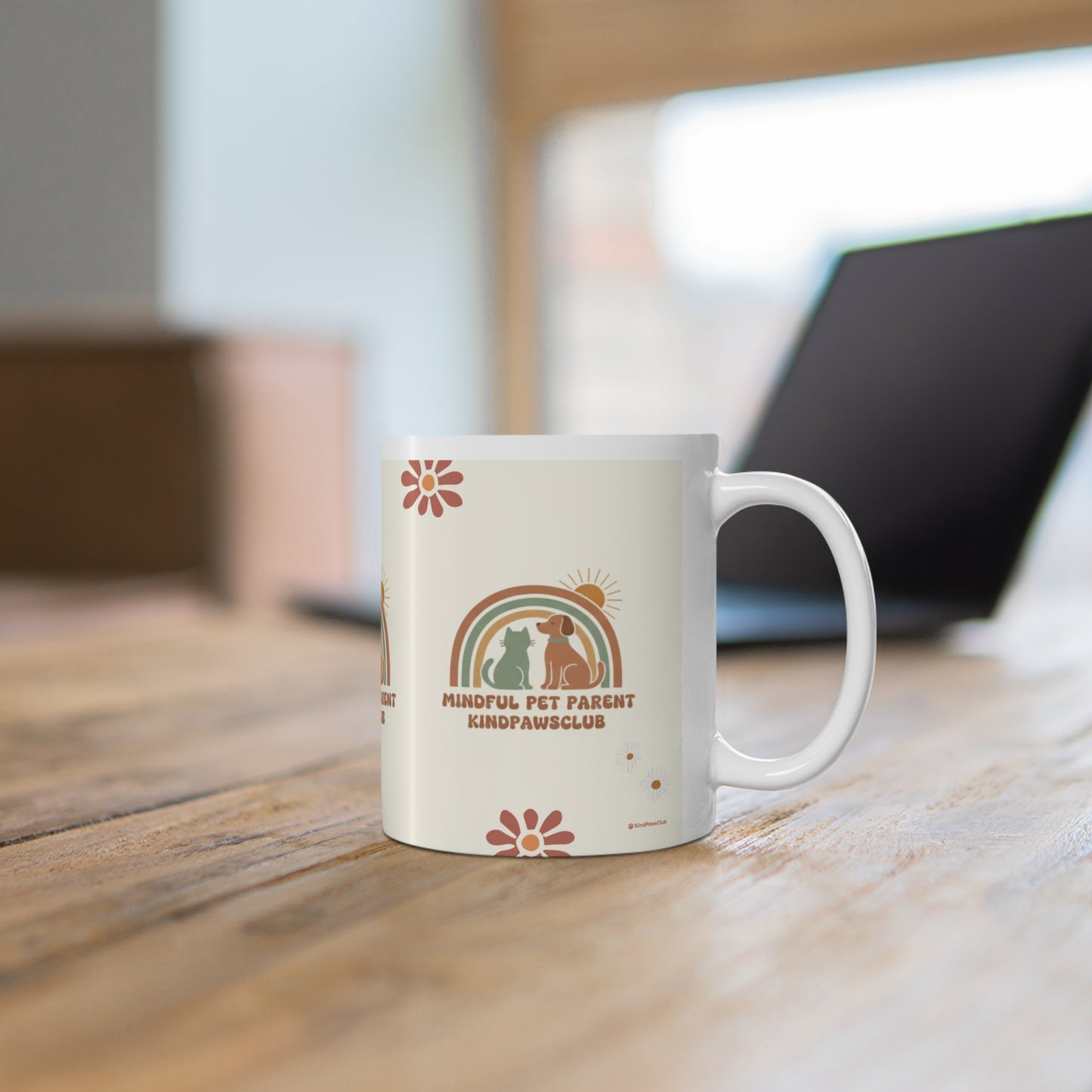 White mug with a colorful design on a wooden surface
