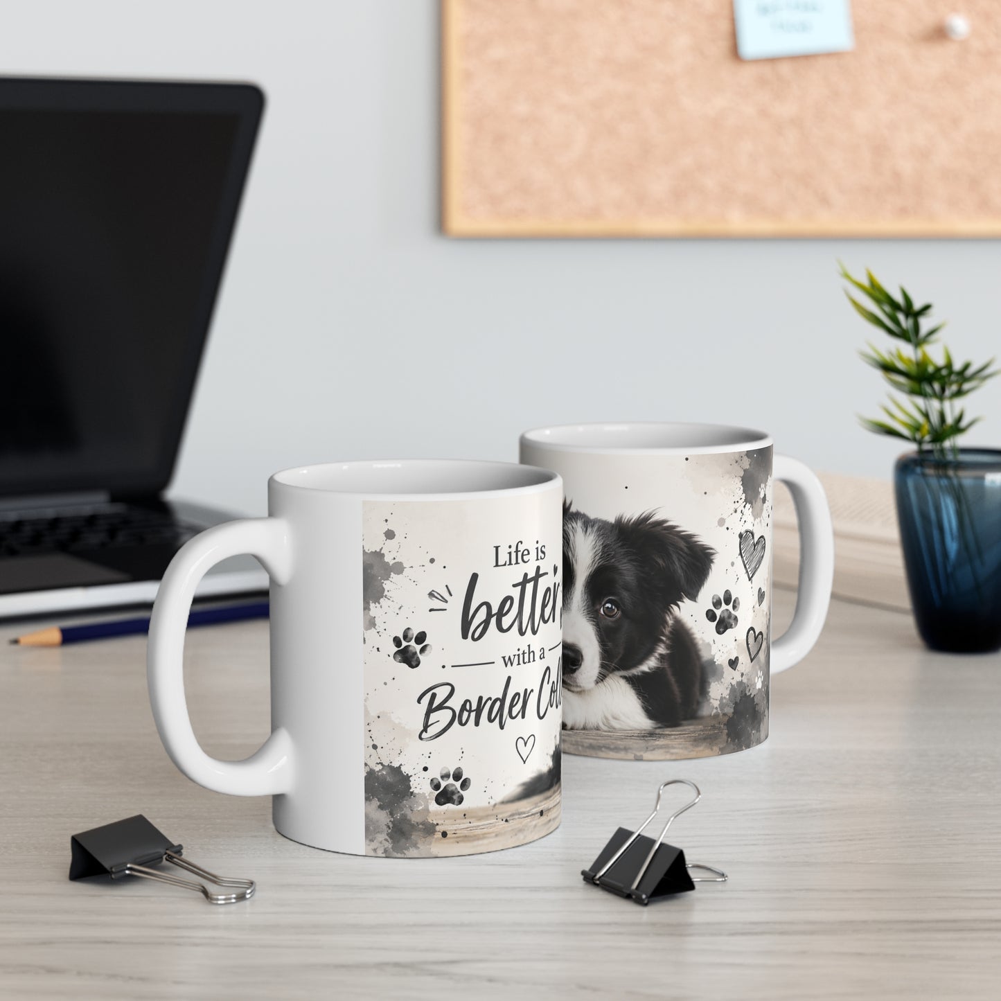 Two mugs on a desk with one featuring a border collie and text 'Life is better with a Border Collie'.