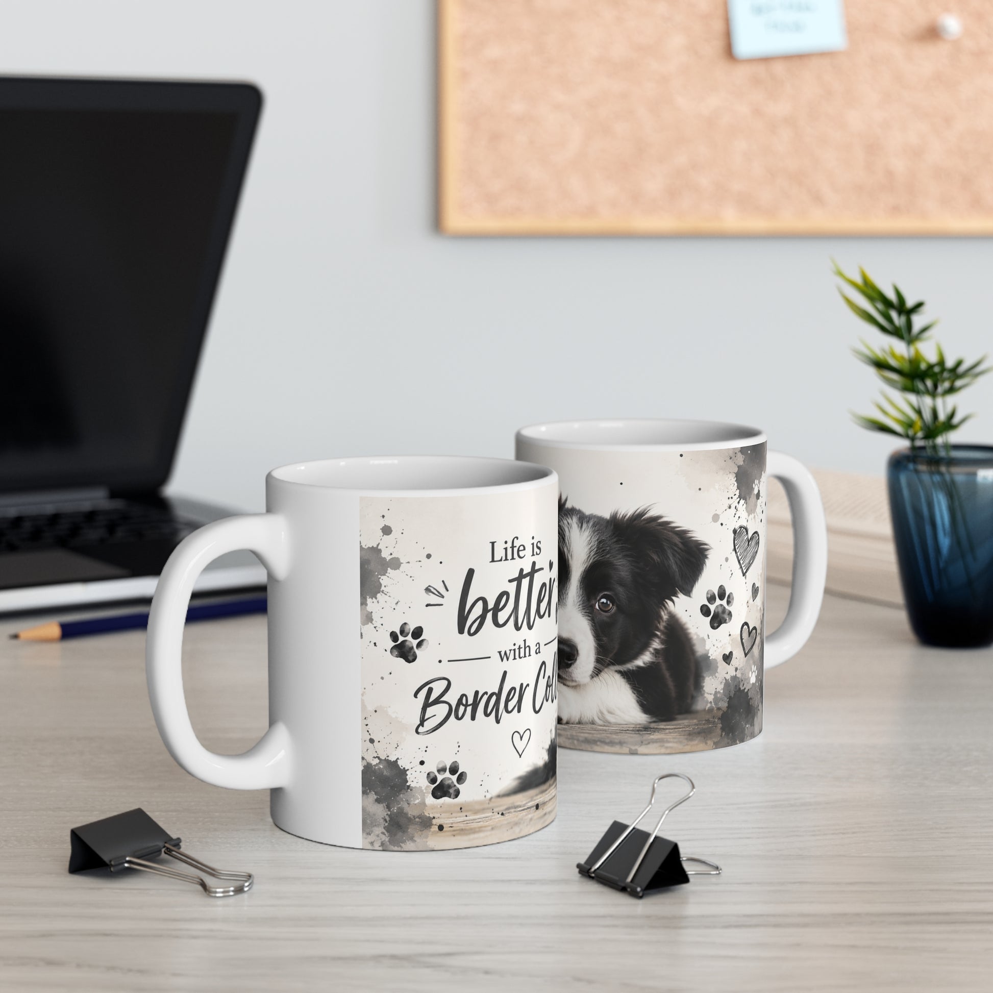 Two mugs on a desk with one featuring a border collie and text 'Life is better with a Border Collie'.